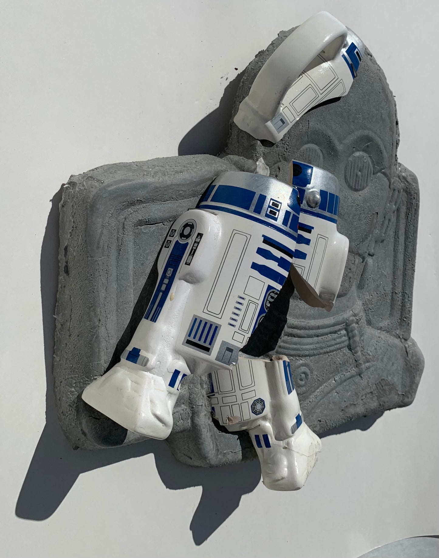 "Cosmic Relief": R2D2 on C3PO Wall Sculpture
