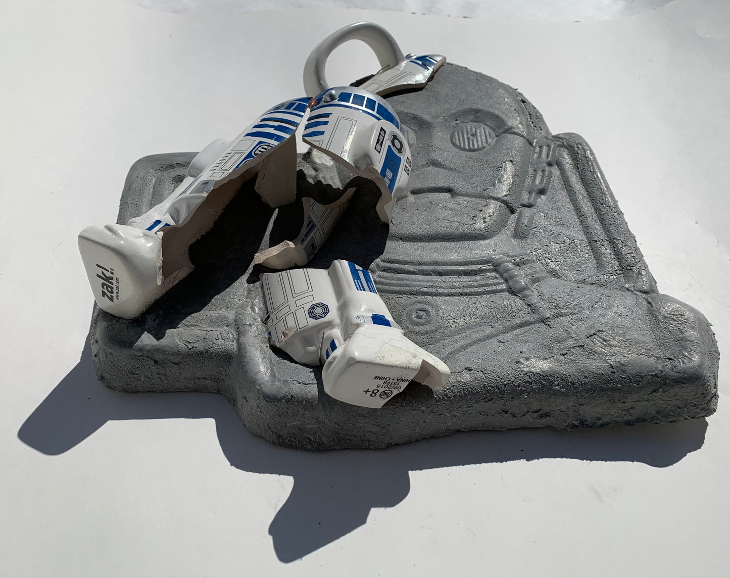 "Cosmic Relief": R2D2 on C3PO Wall Sculpture