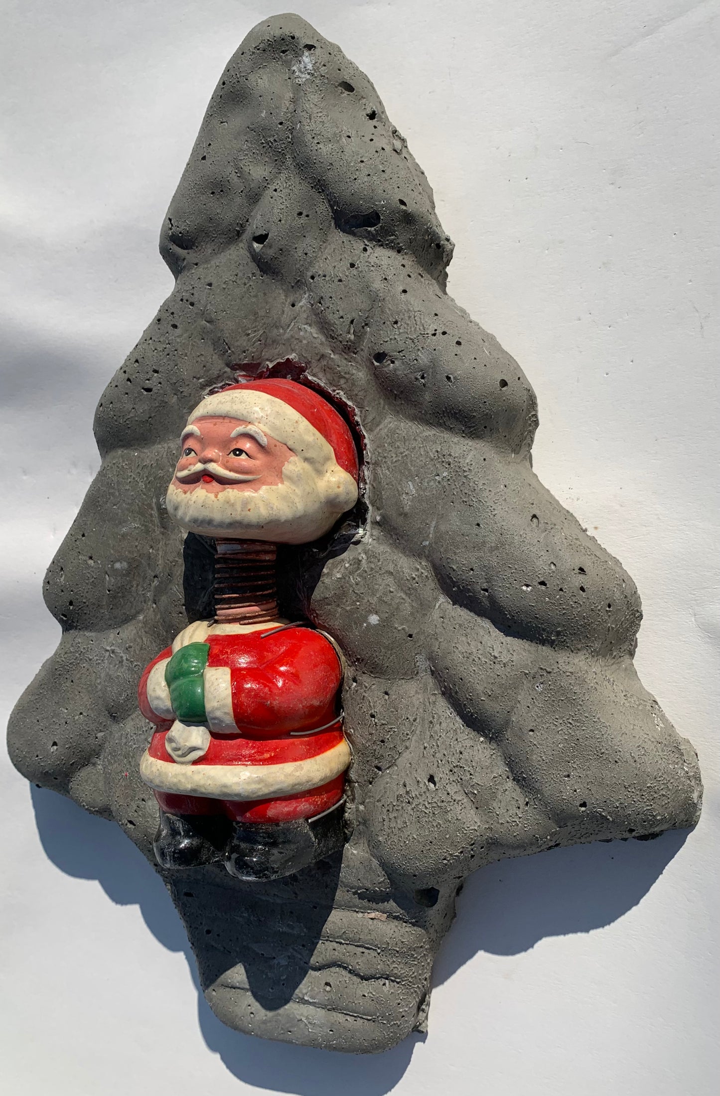 "Spring-Loaded Santa": Bobble Head Santa on Evergreen Tree Wall Sculpture