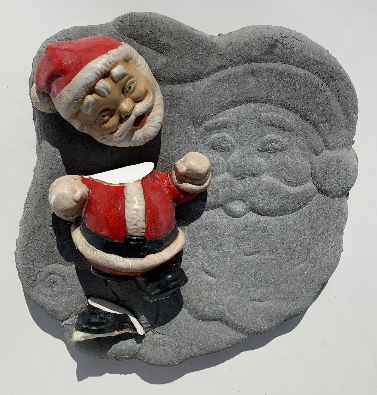 "Seasonal Discombobulation": Club-fisted Santa on Listing Santa Wall Sculpture