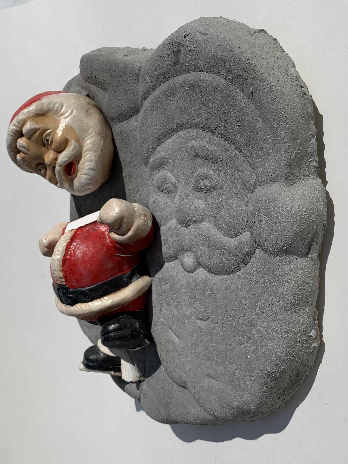 "Seasonal Discombobulation": Club-fisted Santa on Listing Santa Wall Sculpture