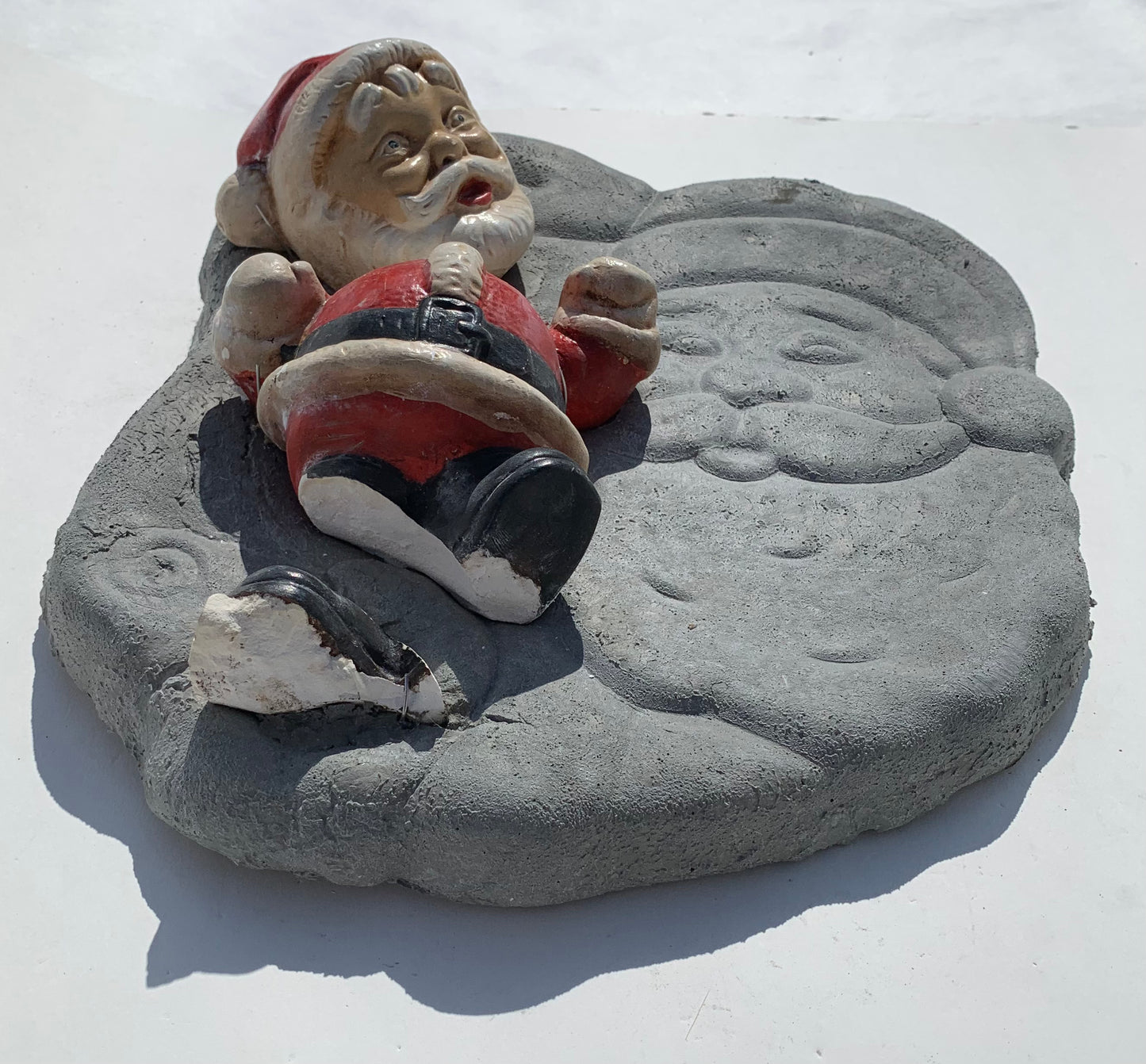 "Seasonal Discombobulation": Club-fisted Santa on Listing Santa Wall Sculpture